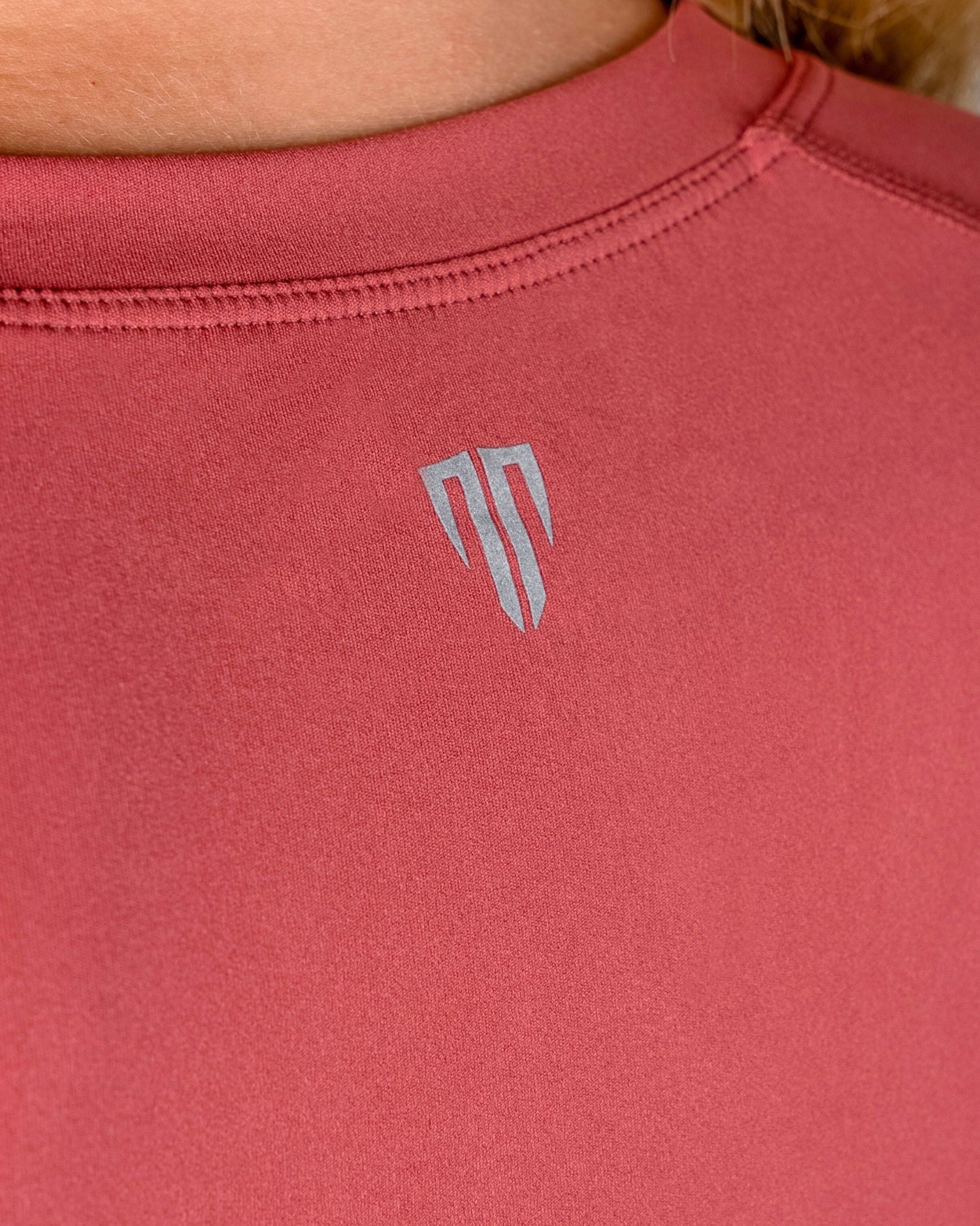 Red athletic shirt with a logo on the back