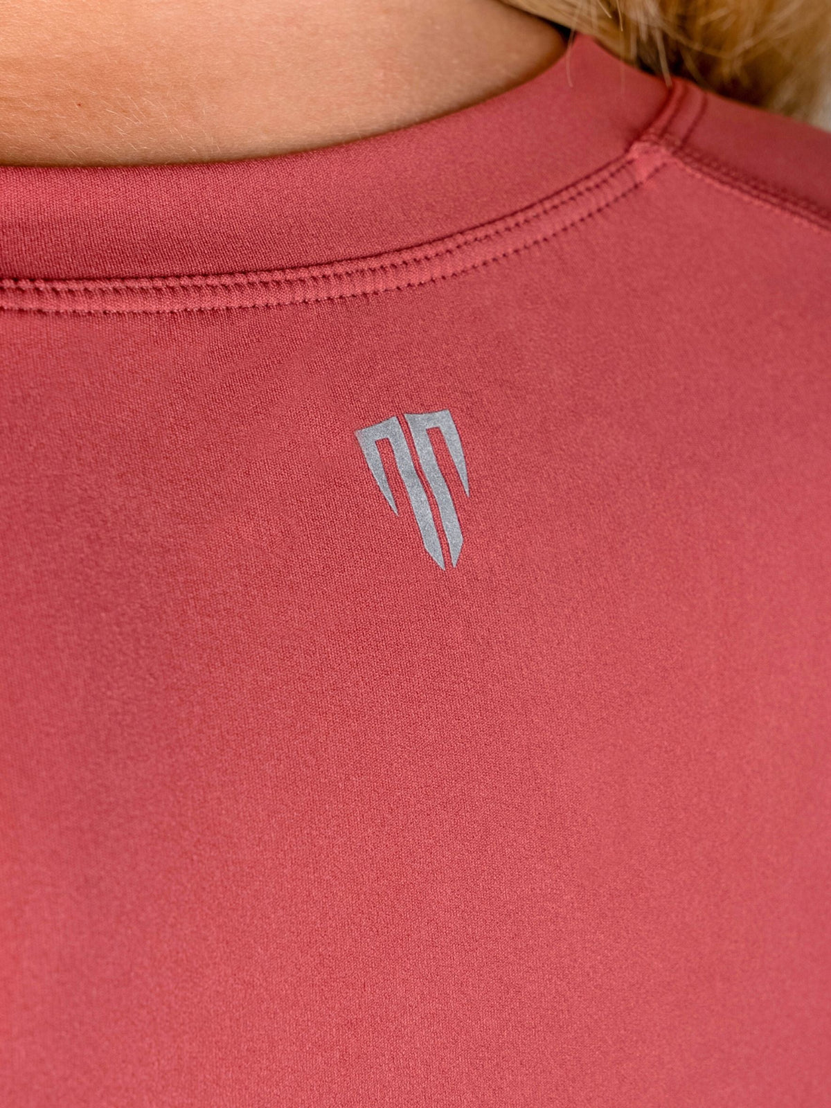 Red athletic shirt with a logo on the back
